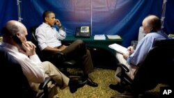 U.S. President Barack Obama is briefed on the situation in Libya on Sunday, during a secure conference call in Rio de Janeiro, Brazil. National Security Advisor Tom Donilon is on the right, Chief of Staff Bill Daley on the left. (Official White House Pho