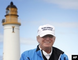 FILE - Republican presidential candidate Donald Trump poses for the media during the third day of the Women's British Open golf championship on Trump's Turnberry golf course in Turnberry, Scotland, Aug. 1, 2015.