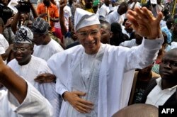 Benin's Prime Minister Lionel Zinsou, a French-Beninese investment banker, waves during a rally after being nominated to fly the party flag for the forthcoming presidential election in Cotonou, Jan. 31, 2016.