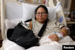 FILE - Paola Bautista, 39, of Fontana, California, sits in her bed at Sunrise Hospital & Medical Center in Las Vegas, Nevada, Oct. 4, 2017. She was one of those shot Oct. 1 at the Route 91 music festival next to the Mandalay Bay Resort and Casino in Las Vegas.