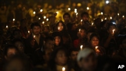 Indians hold candles as they mourn the death of a gang rape victim in New Delhi, India, Saturday, Dec. 29, 2012. 