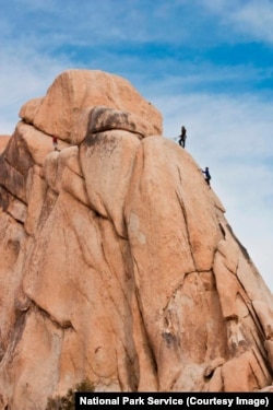 People rock climb at Joshua Tree National Park