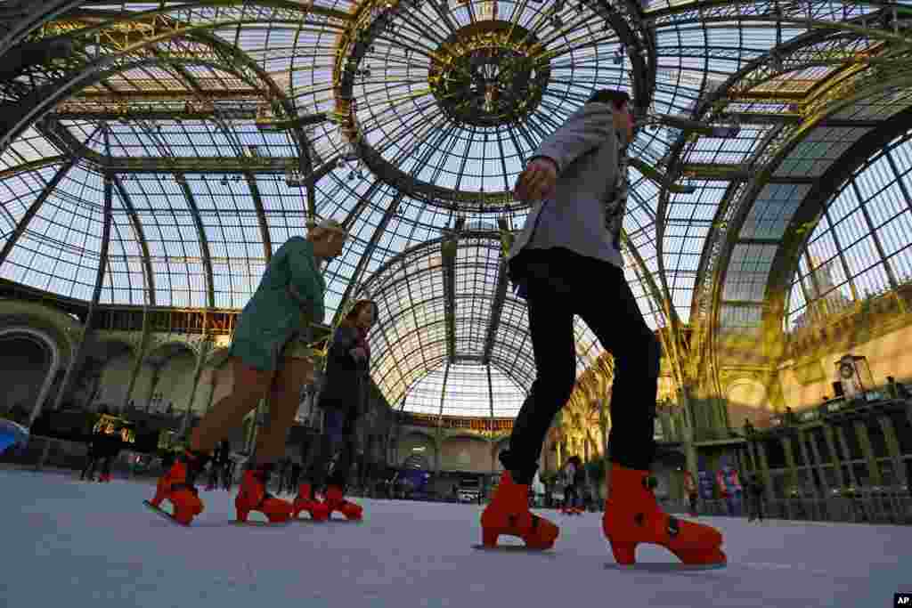 People ice skate at the Grand Palais in Paris, France.