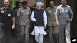 Indian PM Manmohan Singh, center, arrives to make a statement to the media after he was shouted down by opposition politicians in the lower house of Parliament, in New Delhi, India, August 27, 2012.