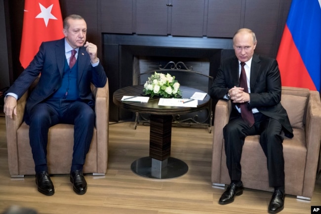 FILE - Russian President Vladimir Putin, right, talks with Turkish President Recep Tayyip Erdogan during their meeting in the Bocharov Ruchei residence in the Black Sea resort of Sochi, Russia, Nov. 13, 2017.