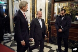 FILE - Secretary of State John Kerry is escorted by Iranian Foreign Minister Javad Zarif 's chief of staff before a meeting with the foreign minister at the Hotel Bristol in Vienna, Austria, Oct. 29, 2015.