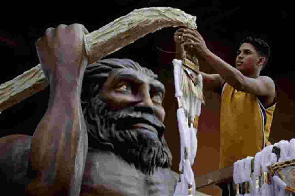 A worker prepares a Carnival float for the Imperatriz Samba school in Rio de Janeiro, Brazil, Thursday, Feb. 24, 2011. Brazil will celebrate Carnival March 4-7. (AP Photo/Felipe Dana)