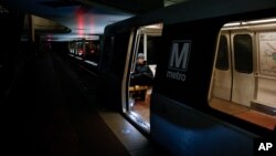 FILE - A lone Metro rider sits on a train in Washington's L'Enfant Plaza Station in this March 2015 photo. 