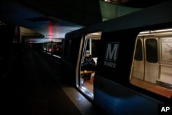 FILE - A lone Metro rider sits on a train in L'Enfant Plaza Metro Station at the height of morning rush hour in Washington, March 5, 2015.