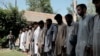 FILE - IS fighters arrested by Afghan security personal stand outside the Afghan police headquarters in Jalalabad, east of Kabul, Afghanistan, May 9, 2016.