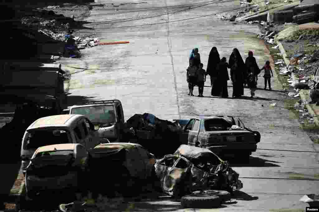 Civilians make their way in western Mosul, Iraq.