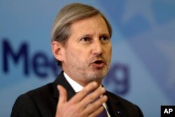 EU Commissioner for Enlargement and European Neighbourhood Policy Johannes Hahn addresses a journalist during a press conference marking the end of a summit of Western Balkan leaders in Sarajevo, Bosnia, March 16, 2017.