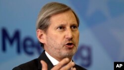 FILE - EU Commissioner for Enlargement and European Neighborhood Policy Johannes Hahn addresses a journalist during a press conference marking the end of a summit of Western Balkan leaders in Sarajevo, Bosnia, March 16, 2017.