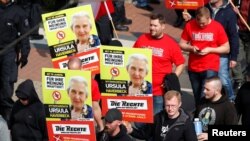 Far-right supporters of the party "Die Rechte (The Rights) carry placards of 90-year-old Ursula Haverbeck, who is imprisoned for her denial of the Holocaust during their May Day rally through the streets of Duisburg, Germany, May 1, 2019.