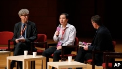 He Jiankui, a Chinese researcher, center, speaks during the Human Genome Editing Conference in Hong Kong, Wednesday, Nov. 28, 2018. He made his first public comments about his claim to have helped make the world's first gene-edited babies.