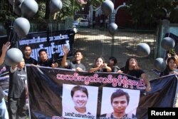 FILE - Journalists protest outside the court where Reuters journalists Wa Lone and Kyaw Soe Oo attend a hearing in Yangon, Myanmar, Jan. 10, 2018.