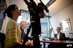 MP for the Greens Cen Ozdemir (R) speaks during an interview with AFP at the parliament in Berlin on Sept, 27, 2018.