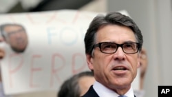 Texas Gov. Rick Perry talks to the media and supporters after he was booked at the Blackwell Thurman Criminal Justice Center, Aug. 19, 2014, in Austin, Texas. 