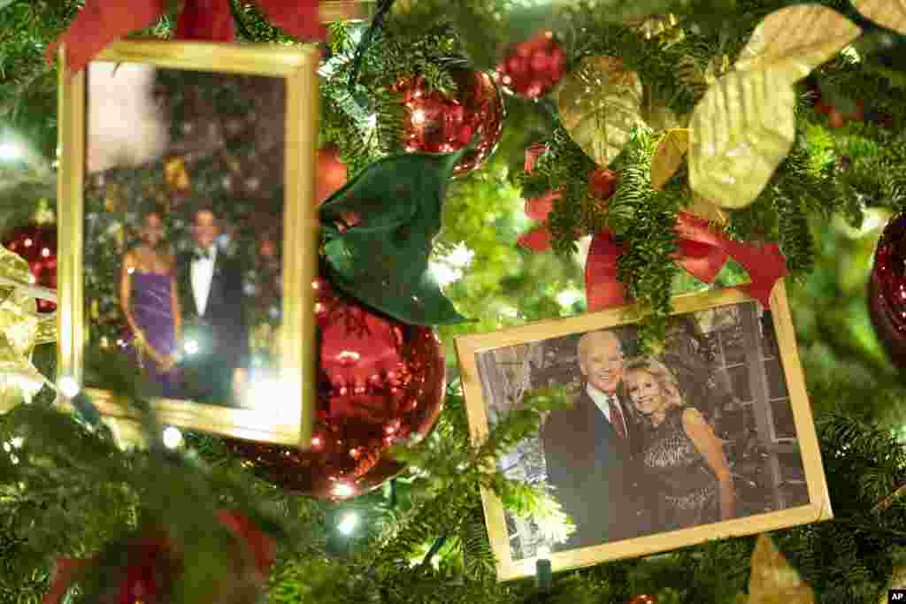 A photo of President Joe Biden and first lady Jill Biden sits in a Christmas tree in the State Dining Room of the White House during a press event for the White House holiday decorations, Monday, Nov. 29, 2021, in Washington. (AP Photo/Evan Vucci)