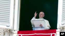 FILE - Pope Francis waves as he leads the Angelus prayer from the window of the Apostolic palace in Saint Peter's Square at the Vatican, Aug. 9, 2015.