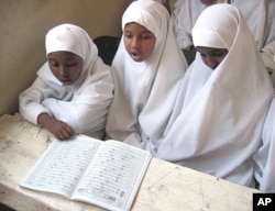 FILE - Students read the Koran during class at a primary school in Hargeisa, Somaliland, Sept. 25, 2006.