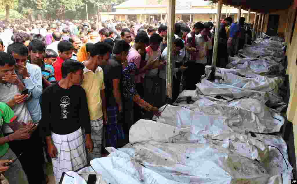 Bangladeshi people identify the bodies of their relatives died in a fire at a garment factory in the Savar neighborhood in Dhaka, Bangladesh, Nov. 25, 2012.