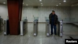 A man exits a metro station during a 24-hour strike in Athens, Greece, Jan. 12, 2018.
