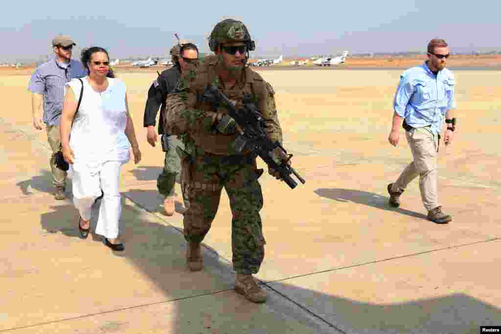 Sgt. Andrew Rodriguez (C), a team leader with Special-Purpose Marine Air-Ground Task Force Crisis Response, leads the U.S. Ambassador to the Republic of South Sudan, Susan D. Page (2nd L), down the flight line during an evacuation of U.S. personnel from Juba in Dec. 2013.