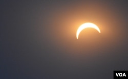 FILE - The moon is seen blotting out 80 percent of the sun during a solar eclipse in Washington, D.C., Monday, Aug. 21, 2017. (Photo: Diaa Bekheet)