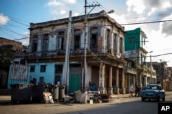 FILE - Garbage containers are placed on a corner in the Centro Havana neighborhood in Havana, Cuba, Oct. 22, 2018.