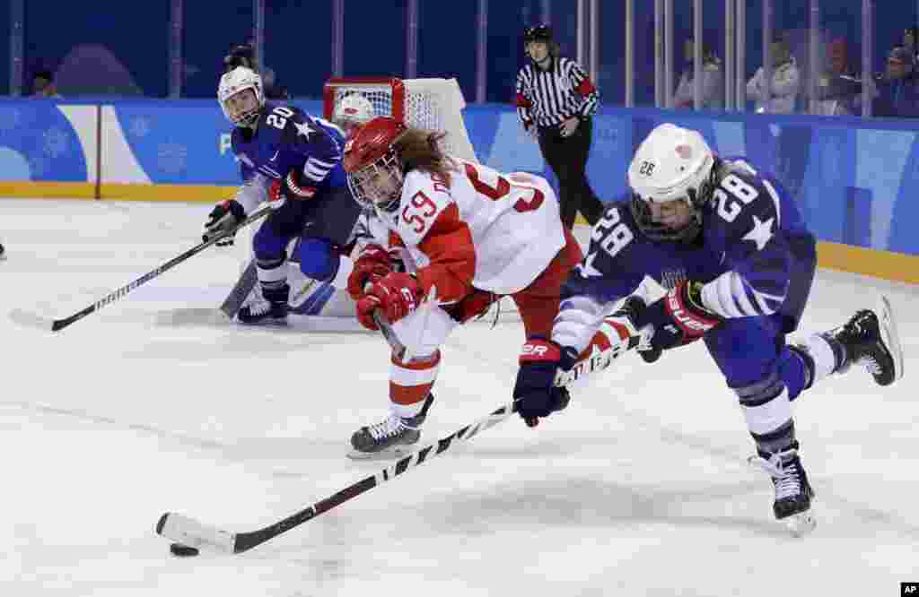 Amanda Kessel (28), of the United States, drives the puck against Russian athlete Yelena Dergachyova (59) during the third period of the preliminary round of the women&#39;s hockey game at the 2018 Winter Olympics in Gangneung, South Korea, Feb. 13, 2018.