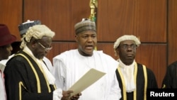 National Assembly Clerk Salisu Maikasuwa (L) swears in Rt. Hon Yakubu Dogara as the new Speaker of the House Of Representatives in Abuja, Nigeria, June 9, 2015. 