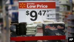 FILE - Towels are on display on a sale rack at a Walmart store in Rogers, Arkansas.