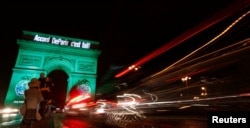 FILE - The Arc de Triomphe is illuminated in green with the words "Paris Agreement is Done," to celebrate the Paris U.N. COP21 Climate Change agreement in Paris, France, Nov. 4, 2016.