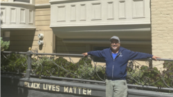 James "Jamie" Juanillo in front of his home
