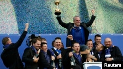 Team Europe captain Paul McGinley (rear) celebrates with players during the closing ceremony of the 40th Ryder Cup at Gleneagles in Scotland Sept. 28, 2014.