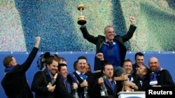Team Europe captain Paul McGinley (rear) celebrates with players during the closing ceremony of the 40th Ryder Cup at Gleneagles in Scotland Sept. 28, 2014.