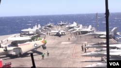 Radar Jet (left) and other jets are pictured on the deck of the USS Ronald Reagan. (Neou Vannarin/VOA Khmer)