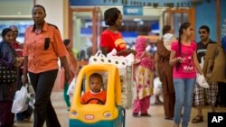 FILE: A boy plays in a supermarket shopping cart at the Westgate Shopping Mall in Nairobi, Kenya, on Sat. July 18, 2015.