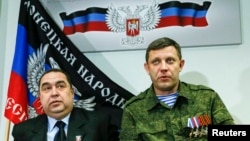 FILE - Alexander Zakharchenko, right, leader of the separatist-controlled area of Donetsk, and Igor Plotnitsky, leader of the separatist-controlled area of Luhansk, attend a news conference in Donetsk, Feb. 2, 2015.