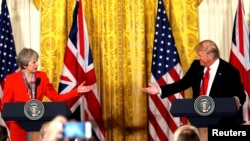 FILE - British Prime Minister Theresa May and U.S. President Donald Trump during their joint news conference at the White House in Washington, Jan. 27, 2017. Both the Trump presidential campaign and the Brexit campaign used Big Data to reach voters.