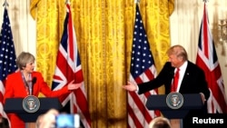 FILE - British Prime Minister Theresa May and U.S. President Donald Trump during their joint news conference at the White House in Washington, Jan. 27, 2017. Both the Trump presidential campaign and the Brexit campaign used Big Data to reach voters.