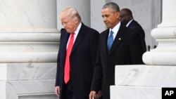 FILE - President Donald Trump walks with former President Barack Obama on Capitol Hill in Washington.