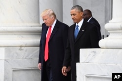 FILE - President Donald Trump walks with former President Barack Obama on Capitol Hill in Washington.