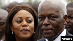 Angola's President Jose Eduardo dos Santos (R) and his wife Ana Paula attend the inauguration of the new Luanda Bay Marginal in the capital Luanda, August 28, 2012. 