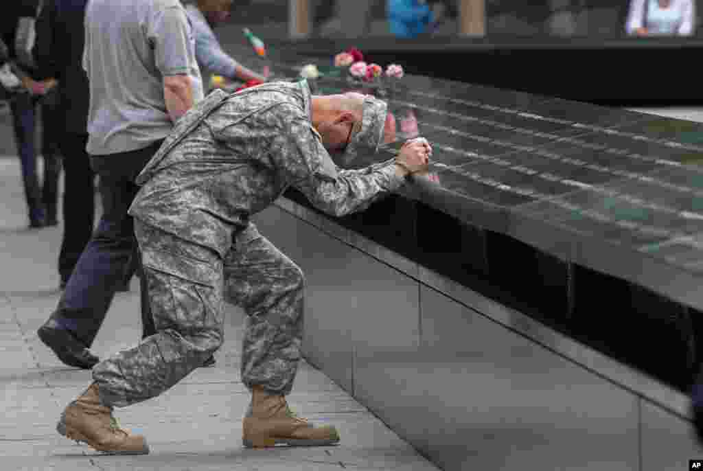 Army Sgt. Edwin Morales prays during a ceremony at the World Trade Center site in New York, Sept. 11, 2015.