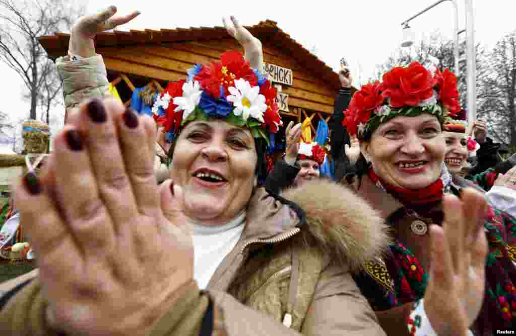 People cheer participants of the regional harvest festival in the town of Dyatlovo, Belarus.