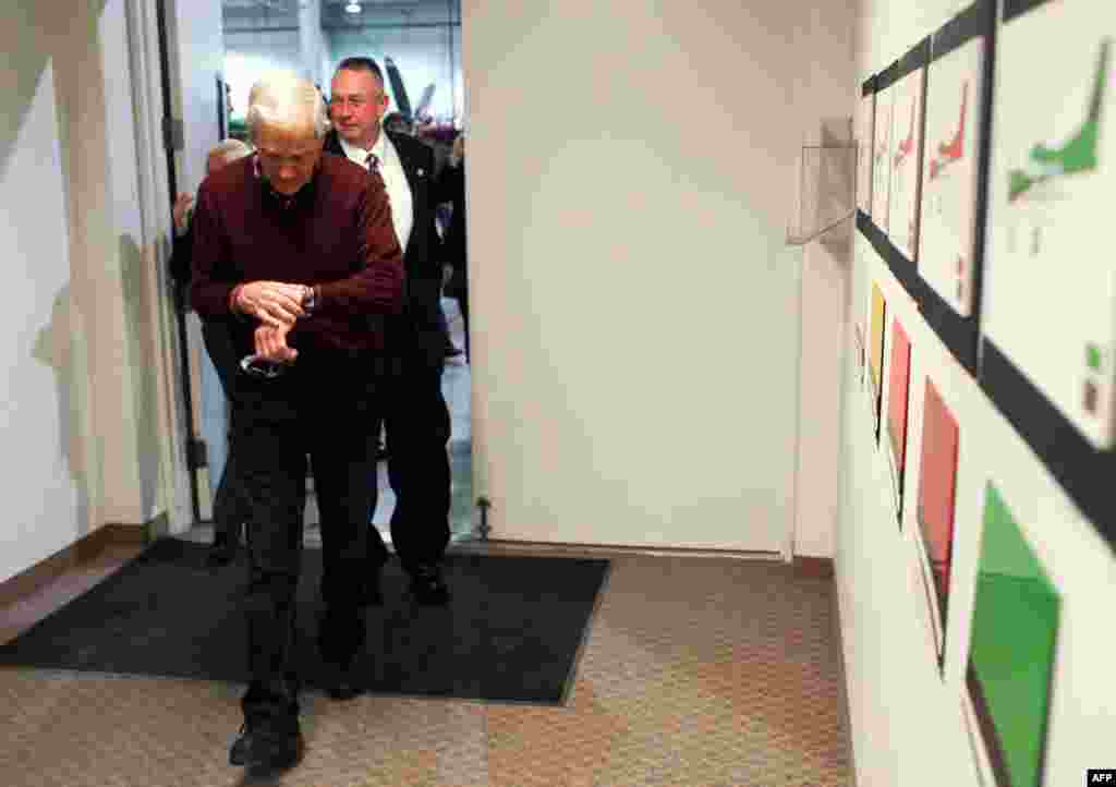 Ron Paul checks his watch as he tours the Quest Aircraft Company in Sandpoint, Idaho, March 5, 2012. (AP)