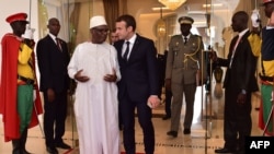 French President Emmanuel Macron, right, walks next to Malian President Ibrahim Boubacar Keita during a G5 Sahel summit, in Bamako, on July 2, 2017, to boost Western backing for a regional anti-jihadist force for the Sahel region amid mounting insecurity and cross-border trafficking.