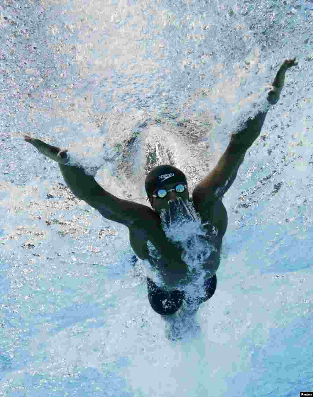 Issa Abdulla Hemed Mohamed of Kenya swims in the men&#39;s 100m Butterfly heats during the 2014 Commonwealth Games in Glasgow, Scotland.